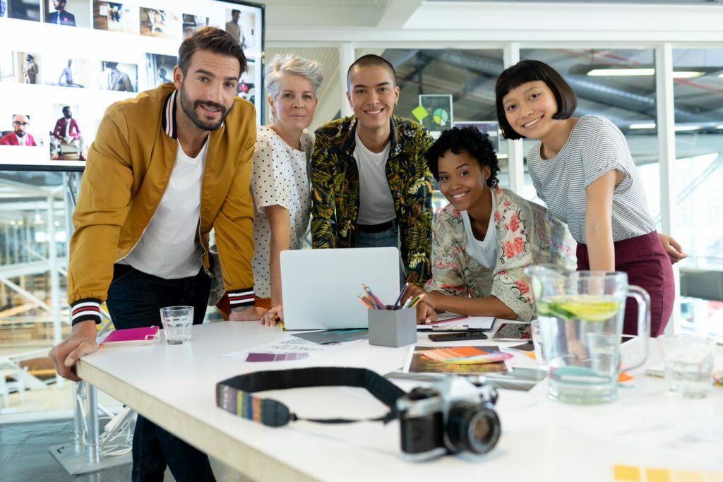 Portrait of diverse business people discussing over laptop in the conference room at office. 