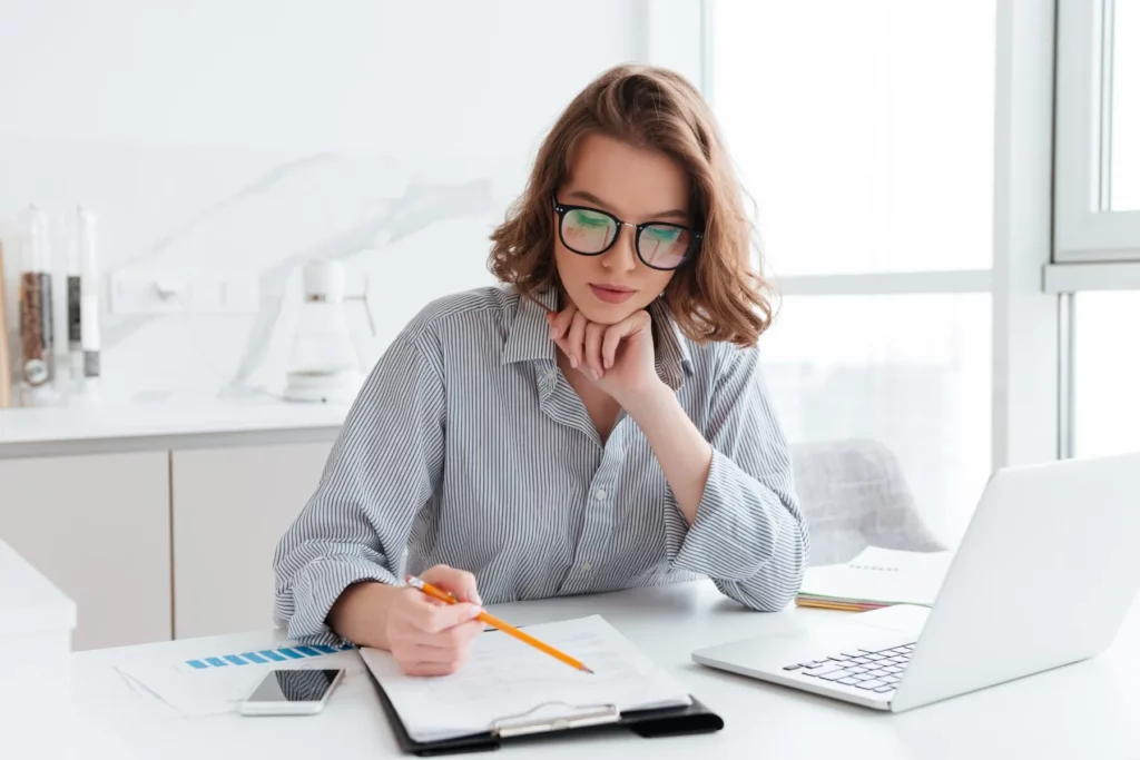 Woman checking her list of blogs to start blogging productively 